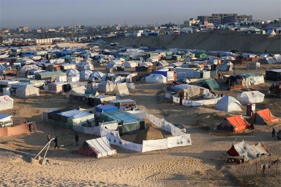Displaced Palestinians take shelter in a makeshift tent camp by the beach in Rafah near the border with Egypt in the southern Gaza Strip on January 16, 2024, amid the ongoing conflict between Israel and the Palestinian militant group Hamas.