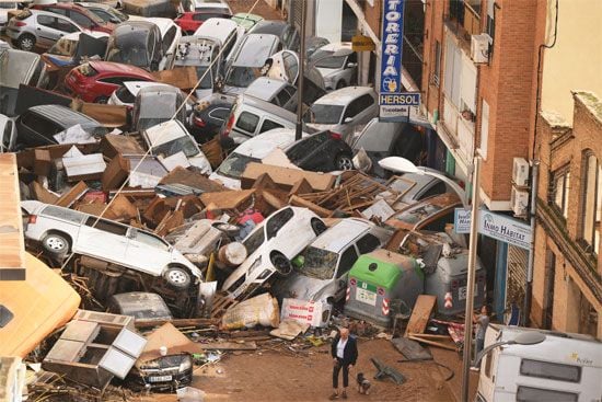 Cars and debris are piled in a narrow street after flash floods hit Sedavi, Valencia, Spain, on October 30, 2024.